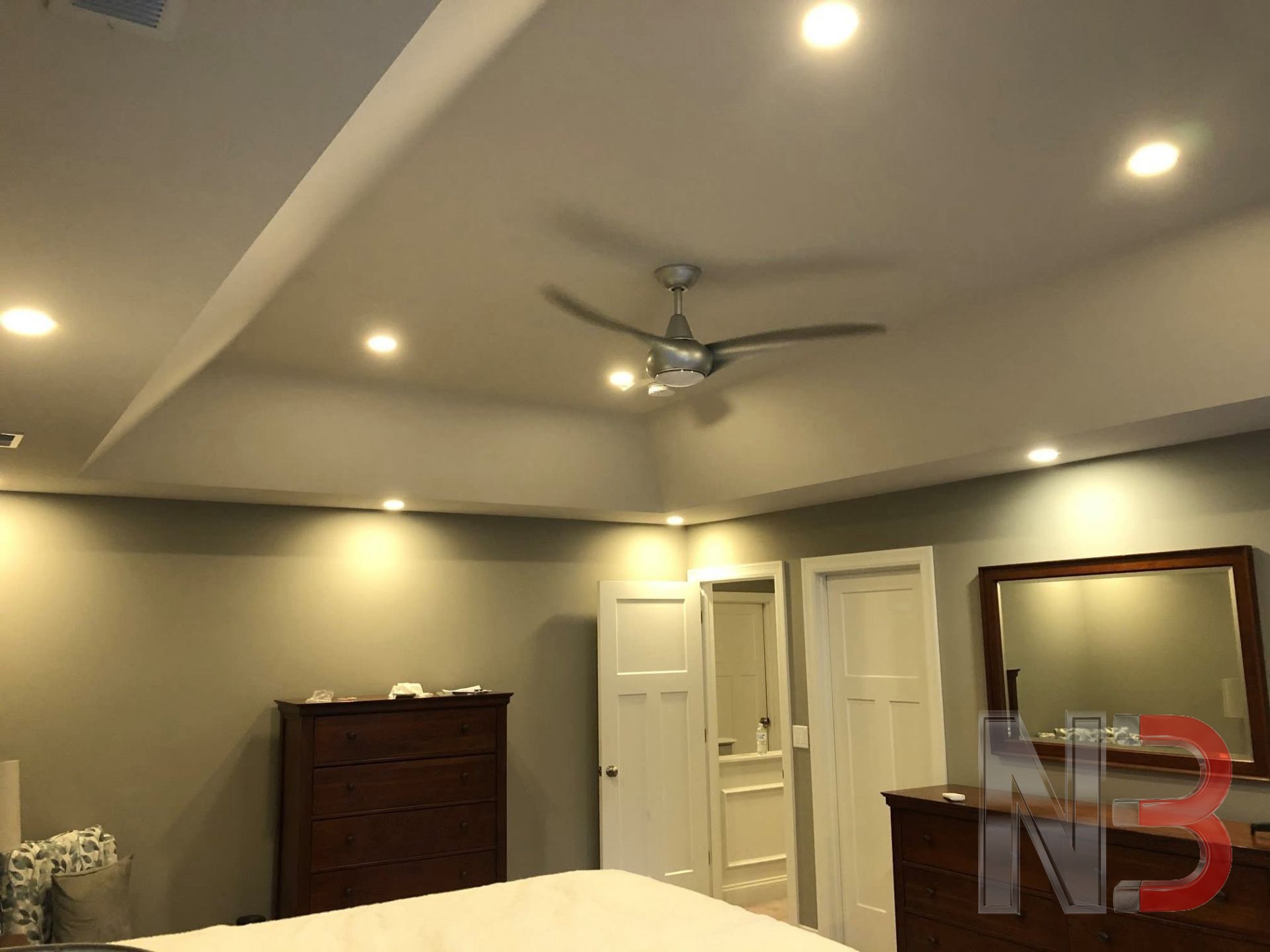 Bedroom tray ceiling with recessed can lights and a new ceiling fan installed