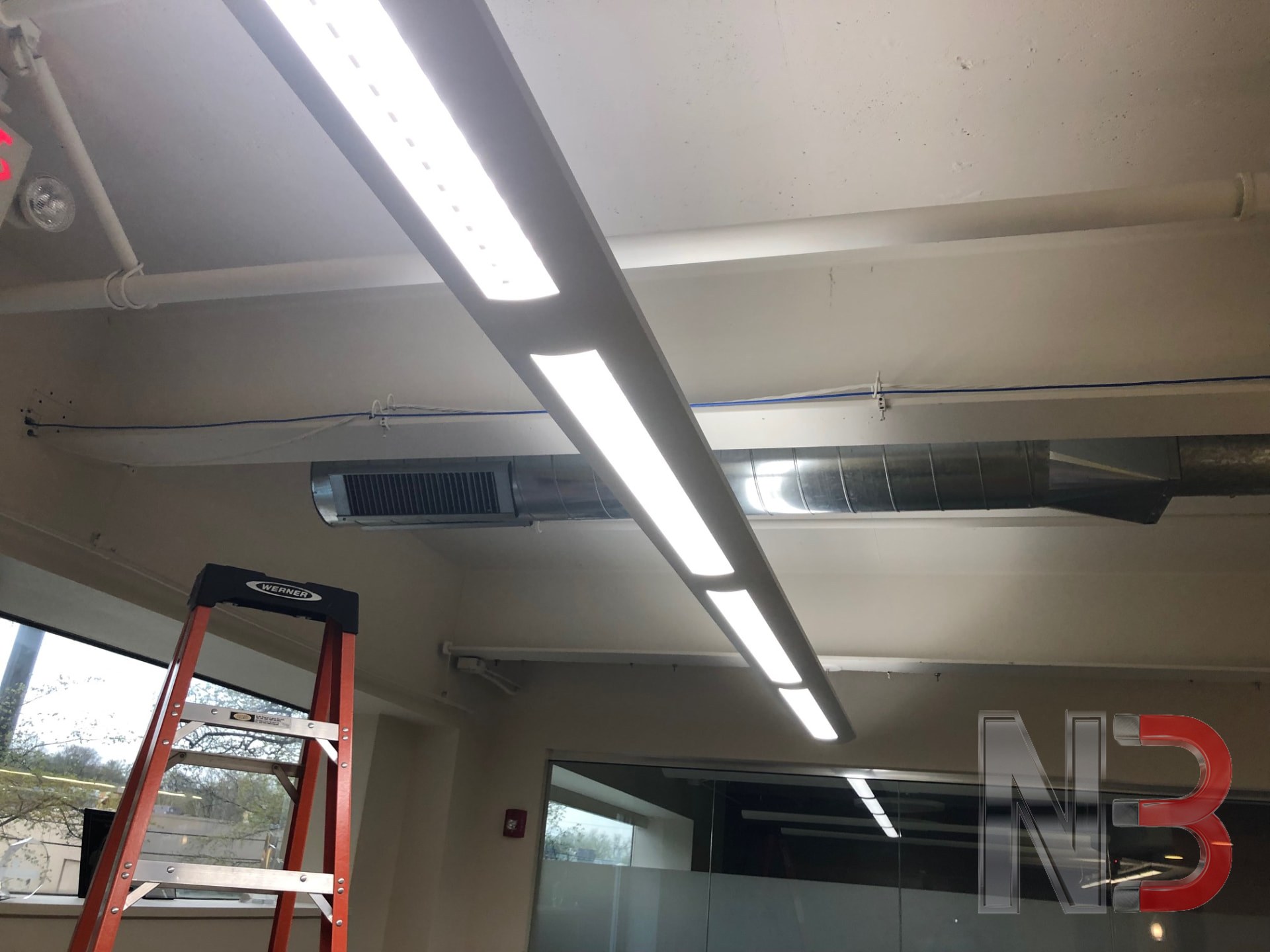New linear LED light fixtures installed in a commercial office ceiling