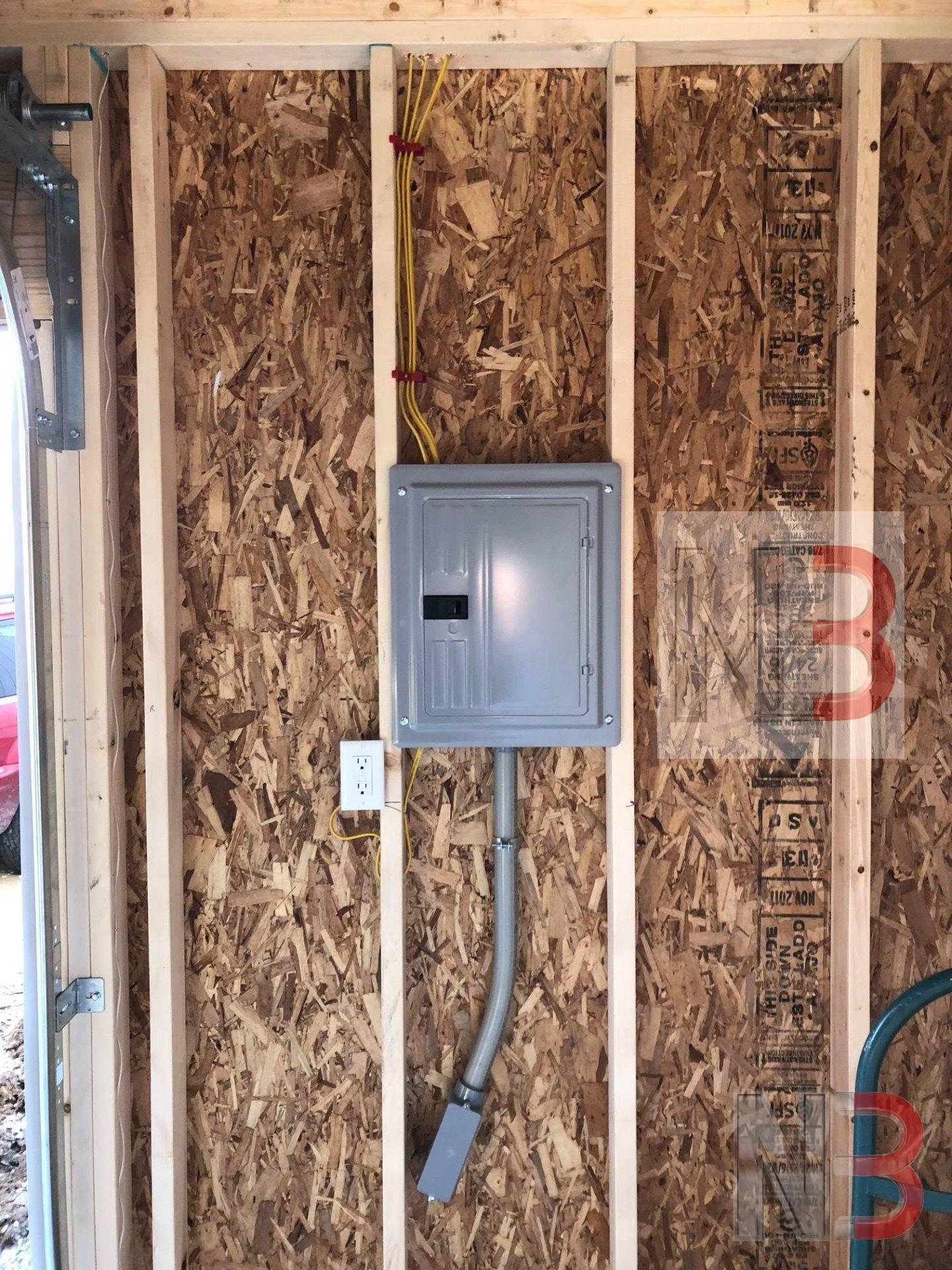 New sub panel installed on framed garage wall with conduit and circuits run