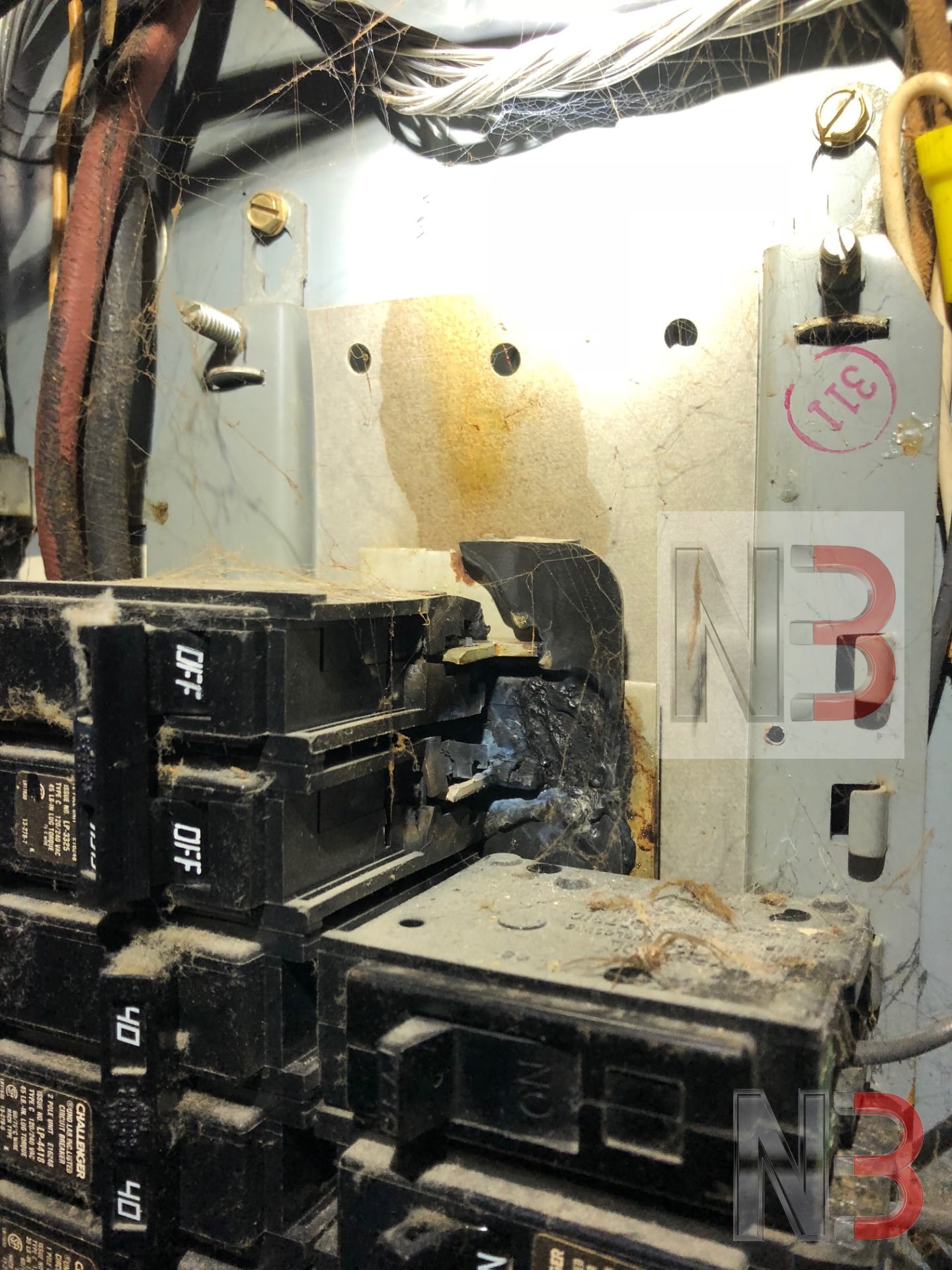 Burnt and damaged breaker inside an old electrical panel found during a troubleshooting call