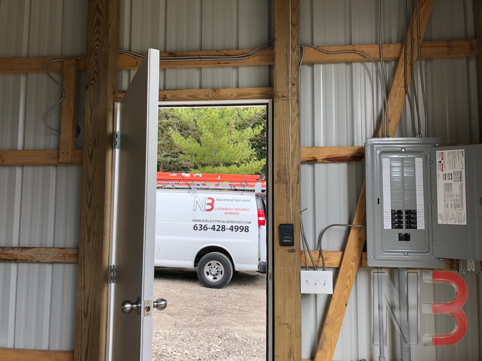 N3 Electrical Services van parked outside a shop building with a newly installed electrical panel inside