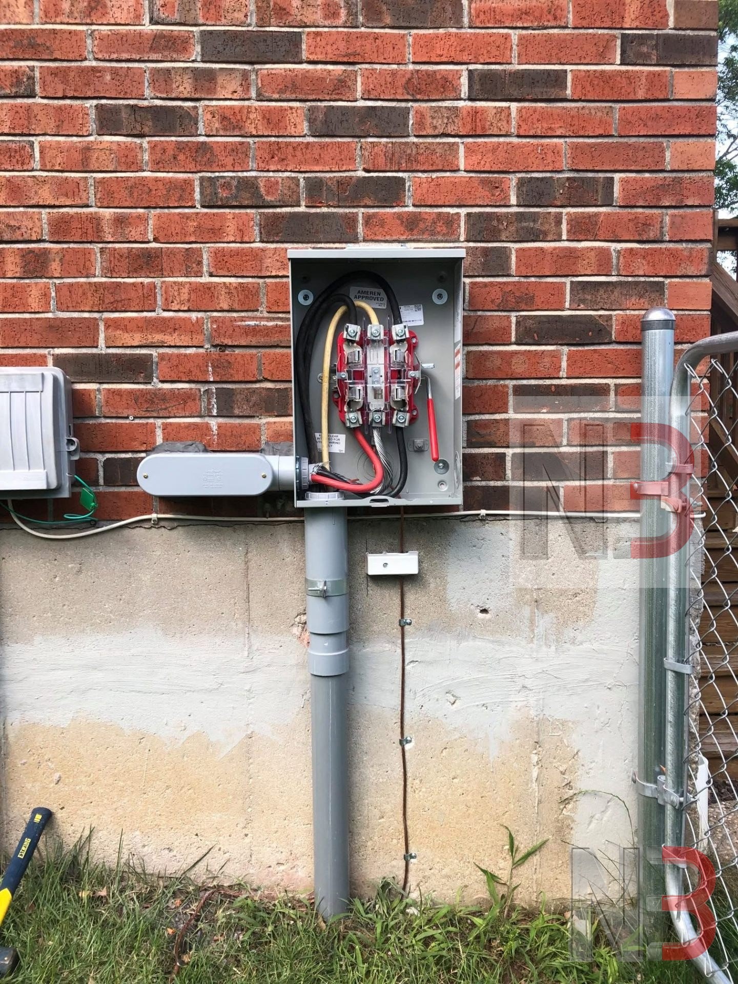 New exterior meter socket and service riser installed on a brick home