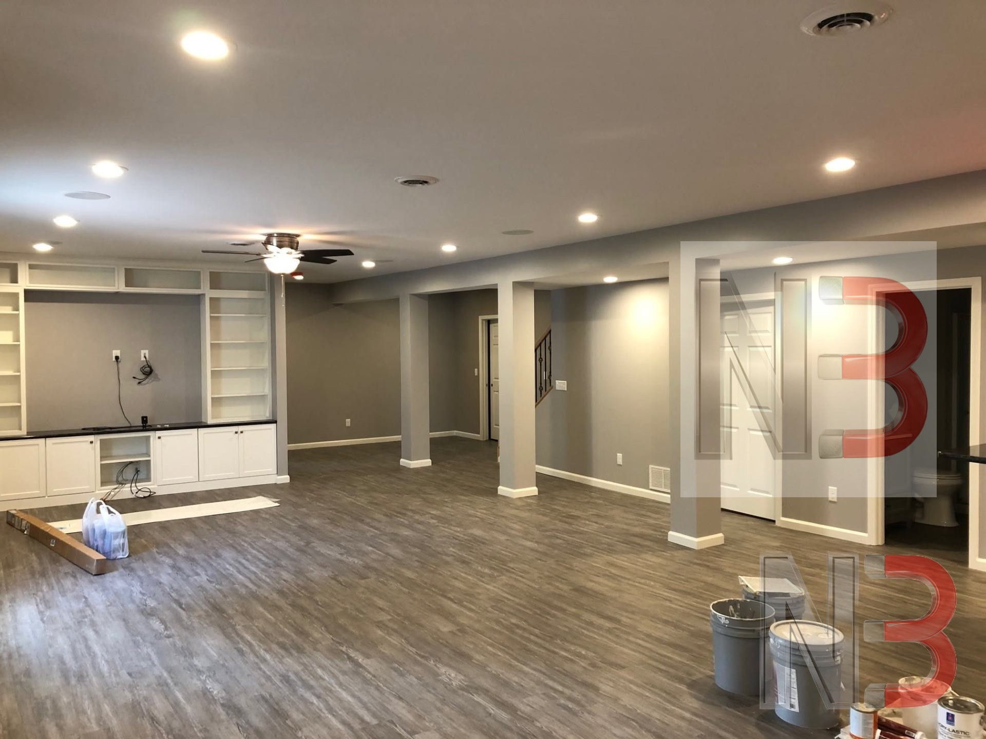 Finished basement with recessed lighting, ceiling fan and built-in cabinetry