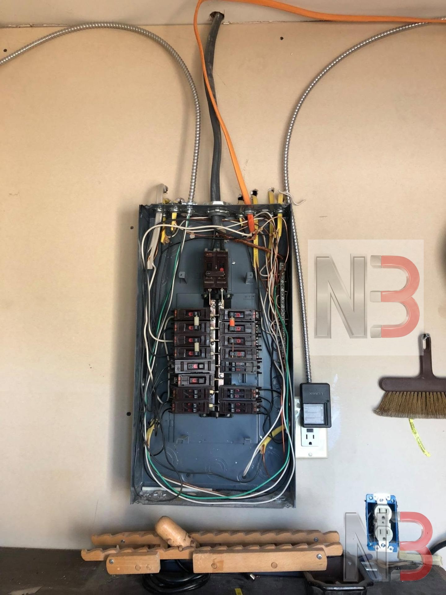 Existing garage breaker panel with cover removed during a service inspection