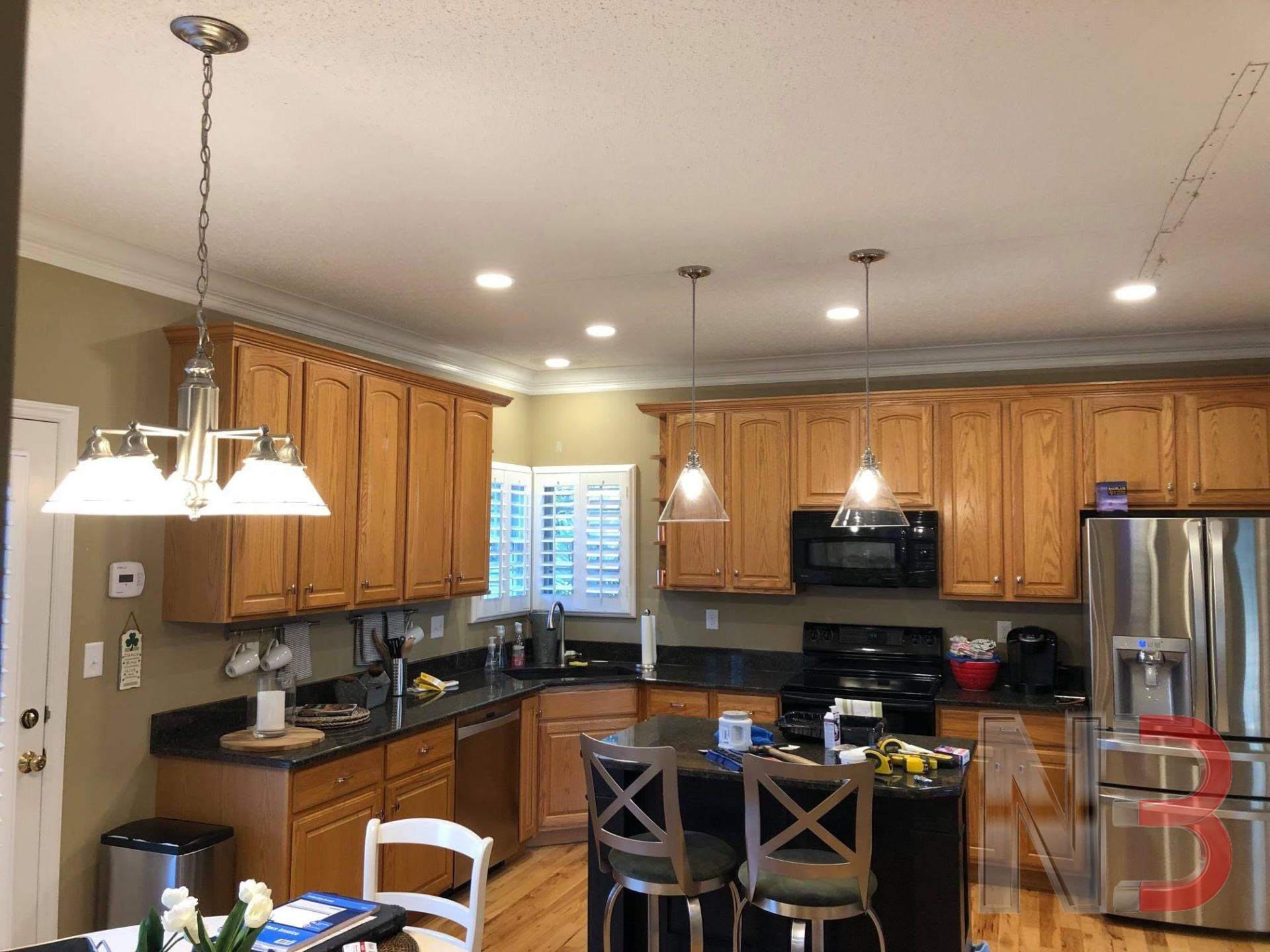 Kitchen with new recessed lighting and pendant lights over the island